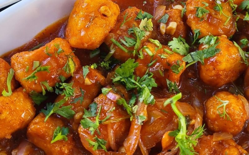 Tantalizing Indian-Chinese fusion dish featuring Manchurian Paneer and flavorful fried rice, perfect for a spicy lunch.